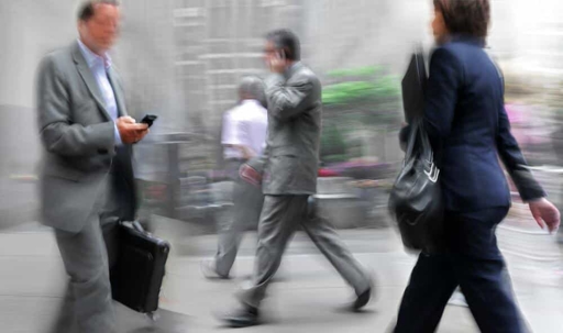People walking while using their cell phones